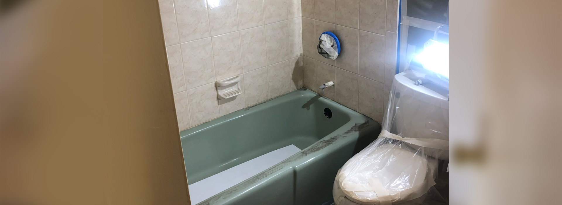 A small bathroom with a toilet and bathtub.