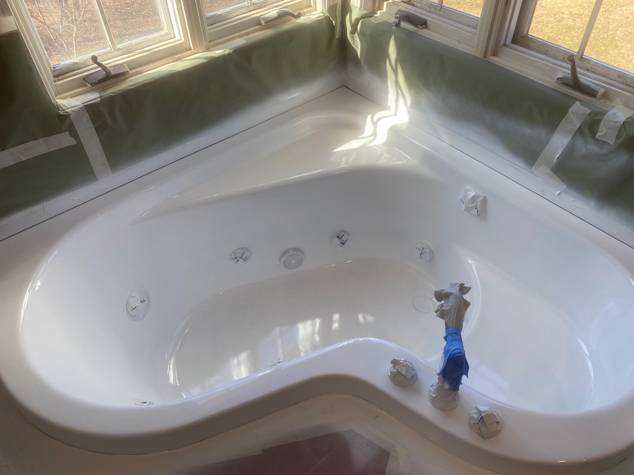 A bathtub is being painted in a bathroom.