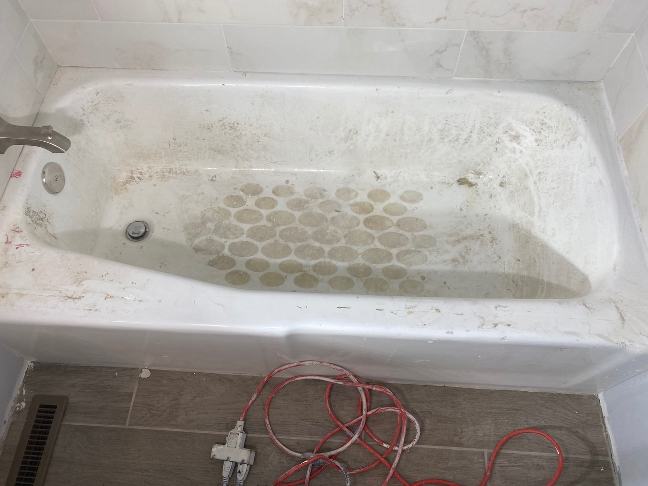 A bathtub that has been cleaned and repainted.