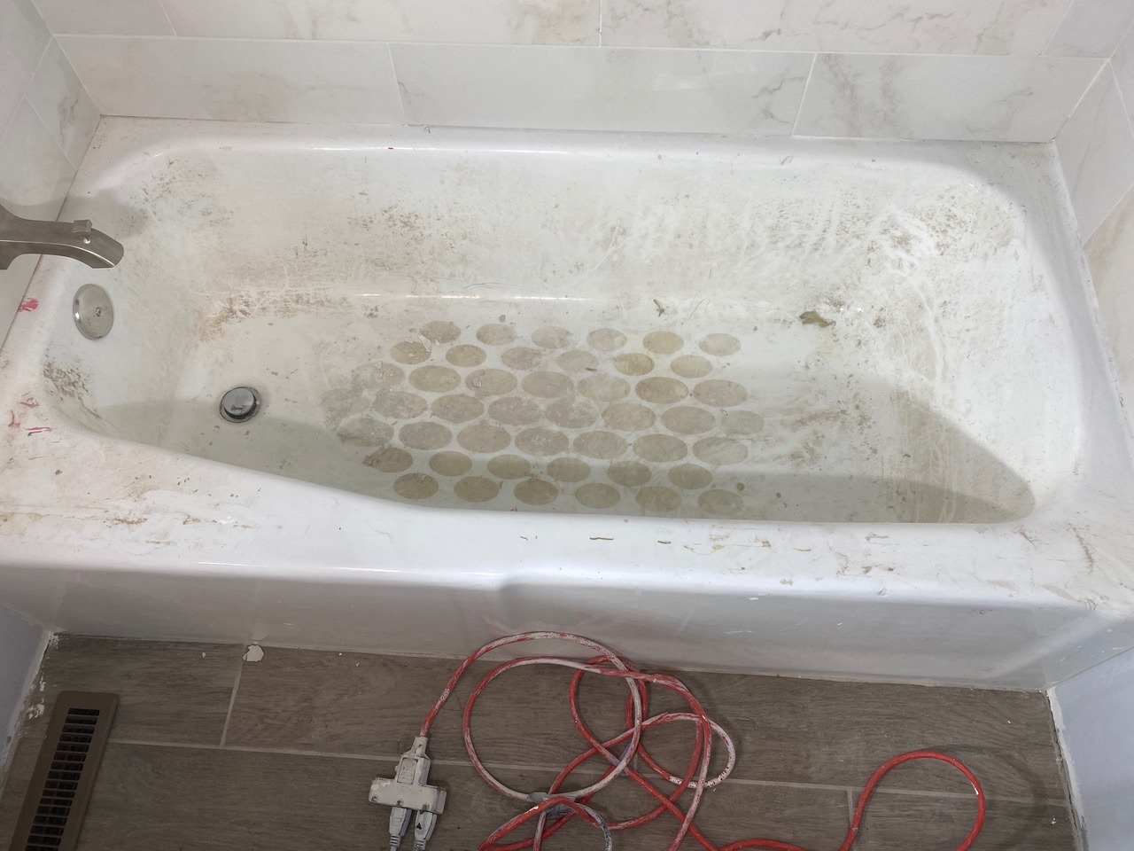 A bathtub that has been cleaned and repainted.