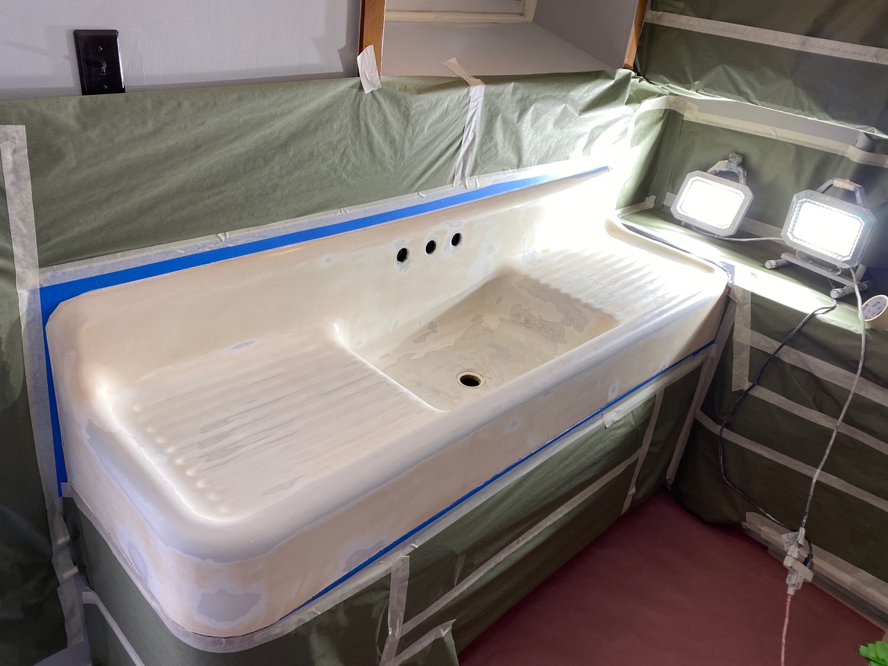 A sink in a room with a tarp covering it.